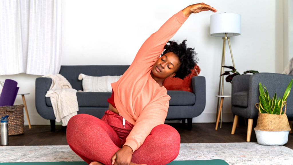 Person stretching indoors for wellness and relaxation in August